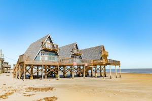 a house on a pier on the beach at Come Enjoy the Best Beach View in Surfside in Surfside Beach +26 photos