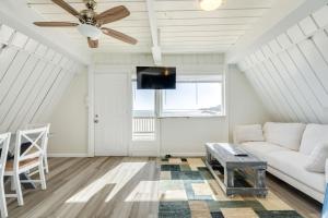 a living room with a white couch and a ceiling fan at Come Enjoy the Best Beach View in Surfside in Surfside Beach