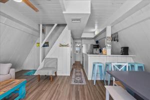 a living room with a couch and a table and chairs at Sleep Over the Ocean in Surfside Beach