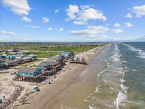 an aerial view of a beach with buildings and the ocean at Sleep Over the Ocean in Surfside Beach