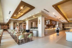 a restaurant with tables and chairs and a bar at Riu Flamingos - All Inclusive in Nuevo Vallarta
