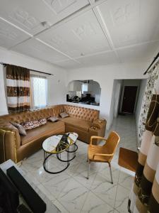 a living room with a couch and a table at Malindi Jerere BnB in Malindi +14 photos