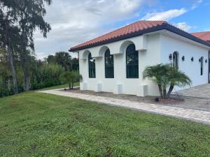 a white house with a green yard at Serene Stays Naples in Naples