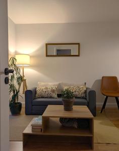 a living room with a blue couch and a table at Trim private rooms in Trim