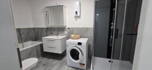 a bathroom with a washing machine and a sink at Luxury View in Westerburg +5 photos