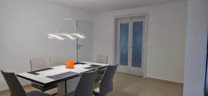 a dining room with a black table and chairs at Luxury View in Westerburg