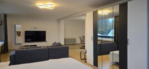 a living room with a couch and a television at Luxury View in Westerburg