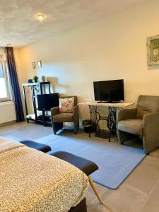 a hotel room with a bed and a desk and a television at Gasterij Hotel Dennenoord in Boxtel