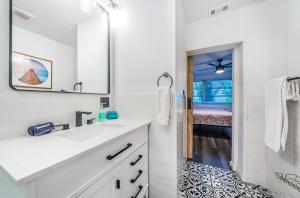 a white bathroom with a sink and a mirror at Hidden Gem 3 Bedroom Home in Largo +26 photos