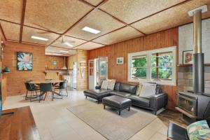 a living room with a couch and a stove at Aloha Amity in Amity Point