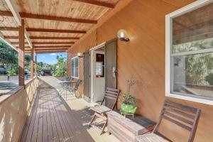 a porch of a house with chairs and a window at Aloha Amity in Amity Point