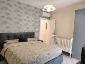 a bedroom with a bed and a baby crib at Holiday Home Varese- Family & Group stay with private parking in Varese