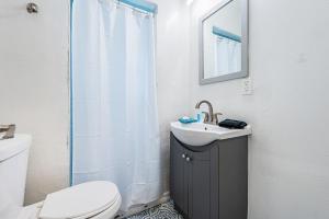 a bathroom with a toilet and a sink and a shower at Sunshine Tropical Villa in Largo +26 photos