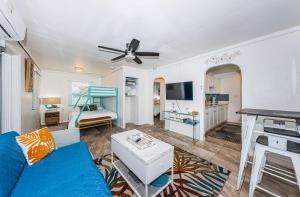 a living room with a blue couch and a bed at Sunshine Tropical Villa in Largo