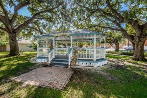 a white gazebo in a park with trees at Teal Tropical Villa in Largo