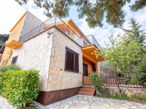 a house with a stone facade and a fence at Kuca Mir Seaside Apartments - 50m from Beach in Ugljan