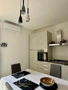 a kitchen with a table with a bowl of food on it at Armonia dell'Etna in Santa Venerina