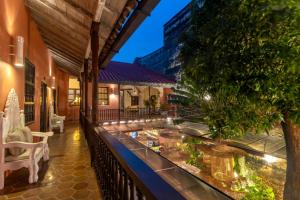 a balcony of a house with a table with food at El Marques Hotel Boutique By GEH Suites in Cartagena de Indias