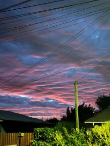 a sunset view from the backyard of a house at Casa Maybell in Chillán