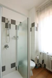 a bathroom with a shower and a toilet at Solferino Green - Modern Stay - Near station in Brescia +5 photos