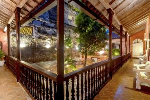 a balcony with a view of a restaurant at El Marques Hotel Boutique By GEH Suites in Cartagena de Indias +70 photos