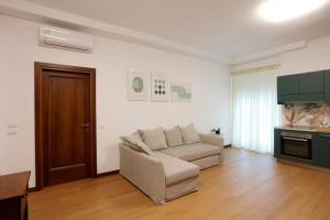 a living room with a couch and a table at Solferino Green - Modern Stay - Near station in Brescia