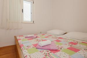 Postel nebo postele na pokoji v ubytování Apartments Rogulj