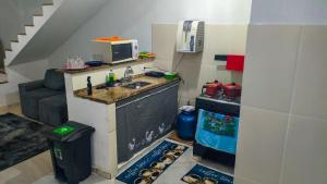a kitchen with a sink and a microwave at Hostel Sundays in Angra dos Reis