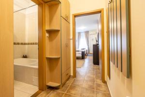 a bathroom with a tub and a toilet and a sink at Gellerico Apartments Wesselényi Street in Budapest +136 photos