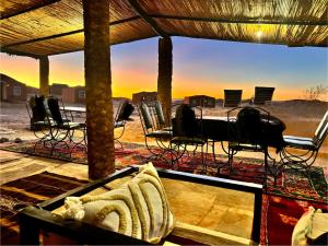 a view of a room with chairs and a table at Bivouac La Dune Blanche in Mhamid