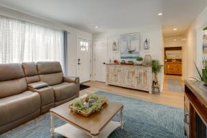 a living room with a couch and a table at Deck, Fire Pit! Fully Updated Home Near Lake Huron in Caseville