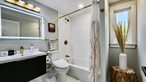 a bathroom with a sink and a toilet and a tub at Luxury New House 6B4B in Arlington +17 photos