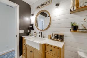 a bathroom with a sink and a mirror at Deck, Fire Pit! Fully Updated Home Near Lake Huron in Caseville
