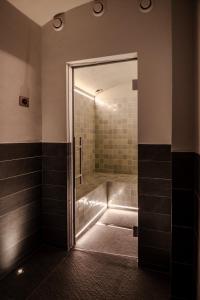 a bathroom with a shower with a glass door at Villa Klainguti in Pontresina +22 photos