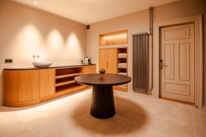 a bathroom with a table and a sink at Villa Klainguti in Pontresina
