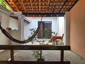 a patio with a hammock in a house at chalé casa na mata céu Iluminado in Guararema