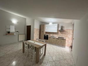 a kitchen with a table and chairs in a room at DR HOUSE in Airola