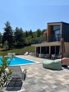 a villa with a swimming pool and a house at Šumska Duša in Banja Luka