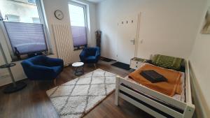 a room with a bed and a chair and a couch at Monteurzimmer 05 in Parchim in Parchim