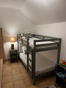 two bunk beds in a room with a lamp at Gite la pause corrézienne in Troche