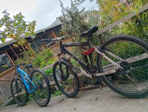 two bikes are parked next to a house at El Corral in Cuenca
