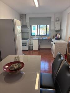 a kitchen with a table with a bowl on top of it at Rolo House in Nazaré