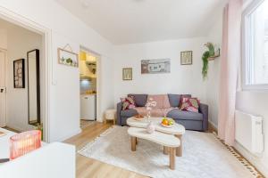 a living room with a couch and a table at Le Cocoon d'Alfortville - Aux portes de Paris in Alfortville