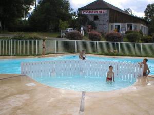 a group of people in a swimming pool at Chalet 4 pers avec Terrasse à Capvern - API-1-52-1745 in Capvern