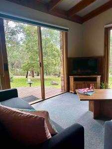 a living room with a large sliding glass door at Halls Gap House in Halls Gap