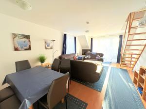 a living room with a couch and a table at Fewo Wellenherz - mit Balkon, 3 SZ, nah am Hafen in Breege
