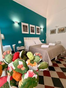 a bedroom with a bed with stuffed animals on the floor at Duomo Rooms b&b in Lentini