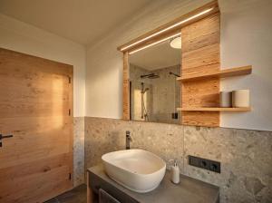 a bathroom with a sink and a mirror at Lodge am Wetterstein in Ehrwald +29 photos