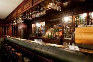 a bar with a lot of bottles of alcohol at Nobile Suites Excelsior Asuncion in Asunción