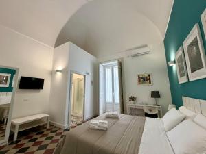 a bedroom with a large bed in a room at Duomo Rooms b&b in Lentini
